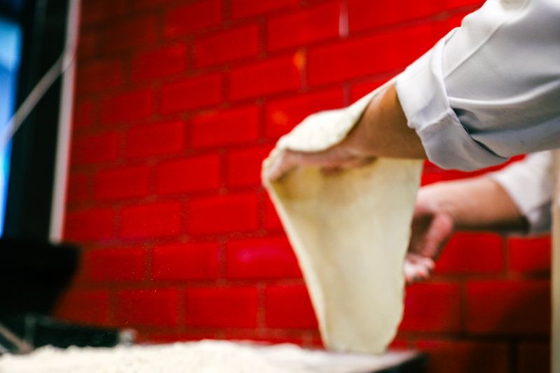 Marcos delivery driver preparing fresh pizza order for delivery
